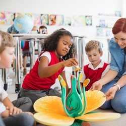 a-group-of-small-school-kids-with-teacher-sitting--G4YGJYK